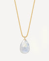 Gold necklace with a teardrop-shaped blue lace agate pendant on a light gray background