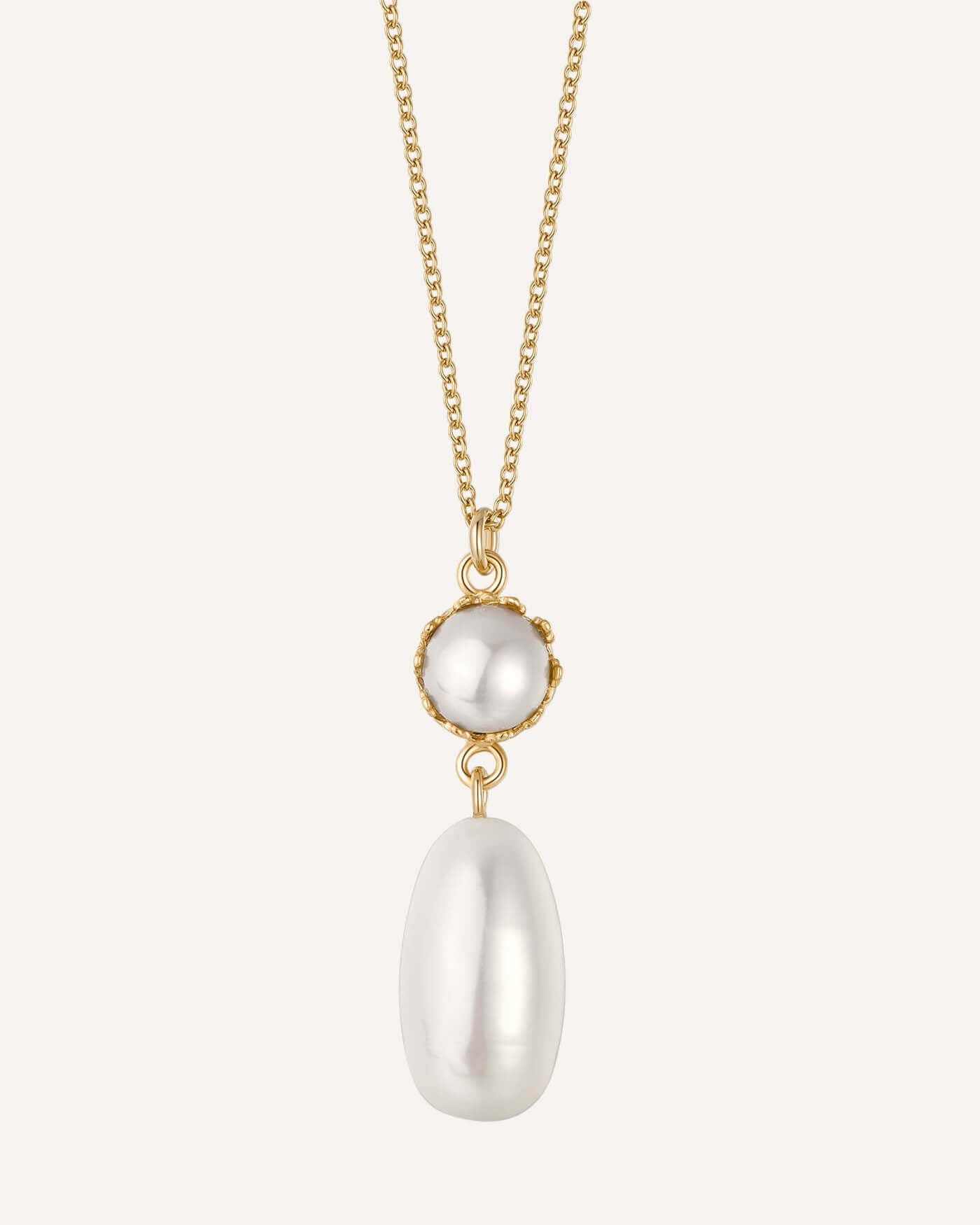 Gold necklace with two white pearls on a white background