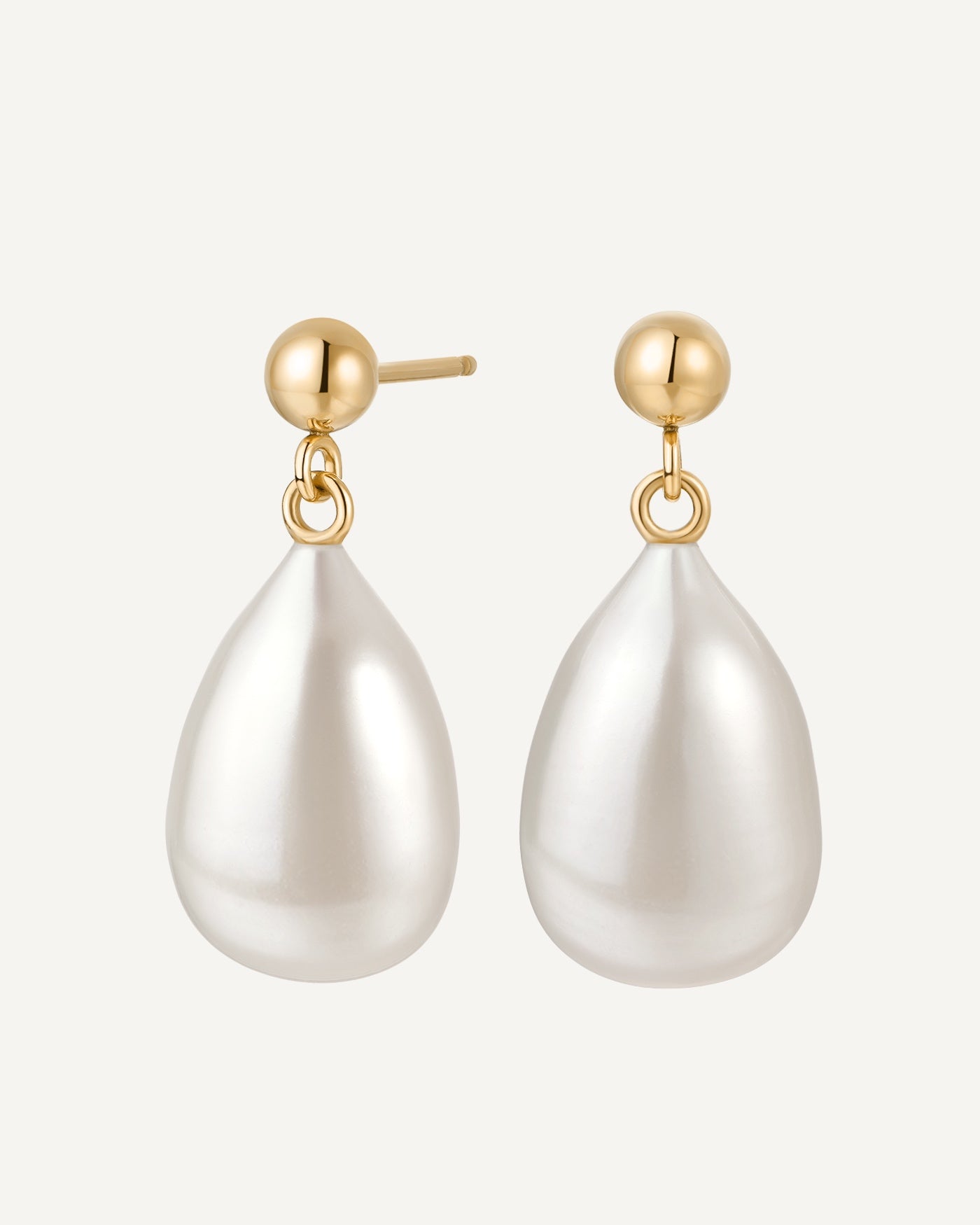 Pearl drop earrings with gold posts on a white background