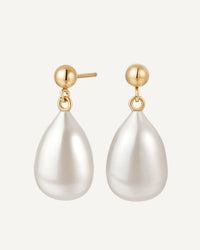 Pearl drop earrings with gold posts on a white background