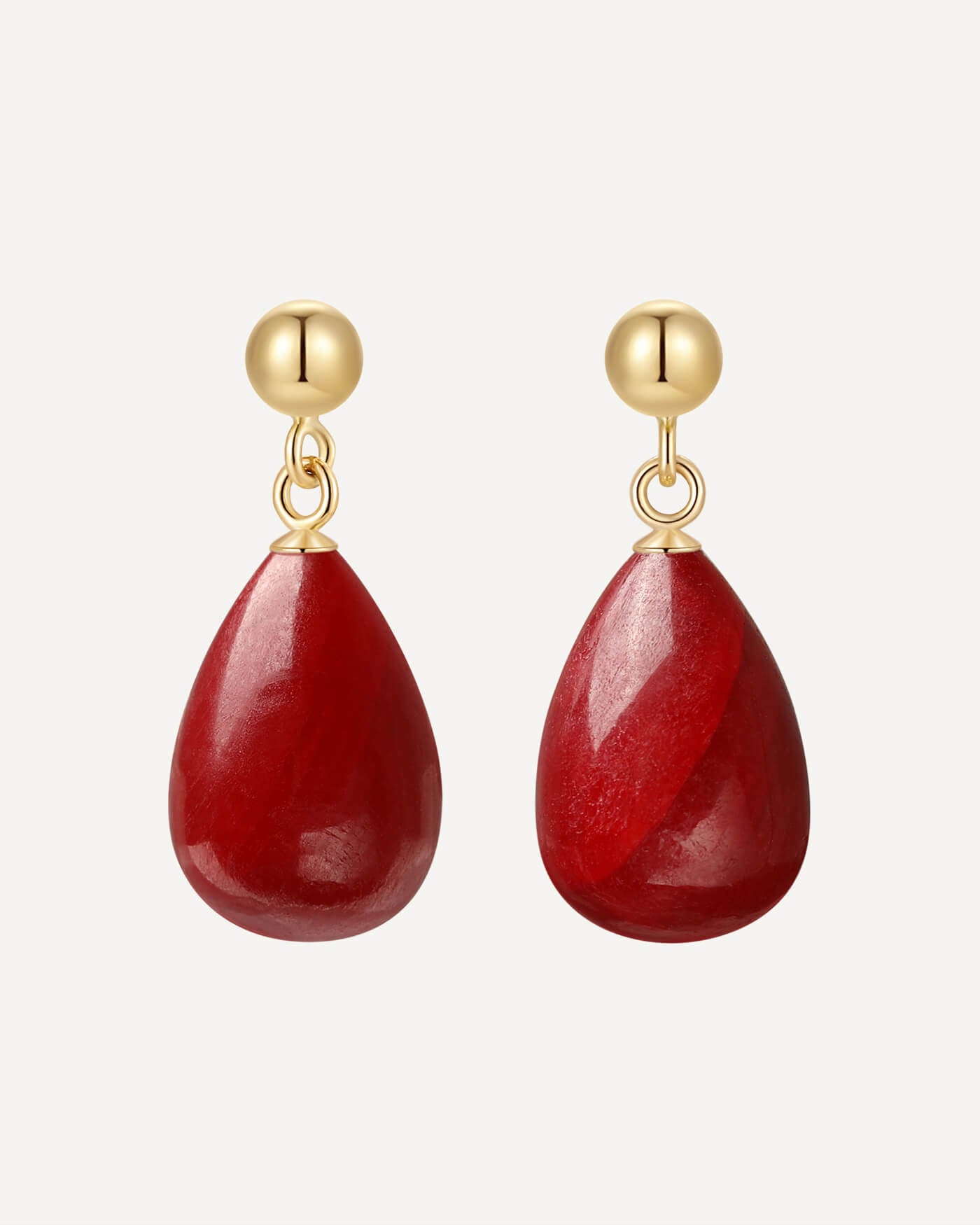 Red teardrop earrings with gold hooks on a white background