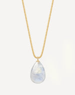 Gold necklace with a teardrop-shaped blue lace agate pendant on a light gray background