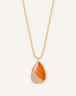 Necklace with a teardrop-shaped orange and white pendant on a gold chain against a white background