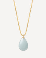 Gold necklace with a teardrop-shaped light blue pendant on a white background