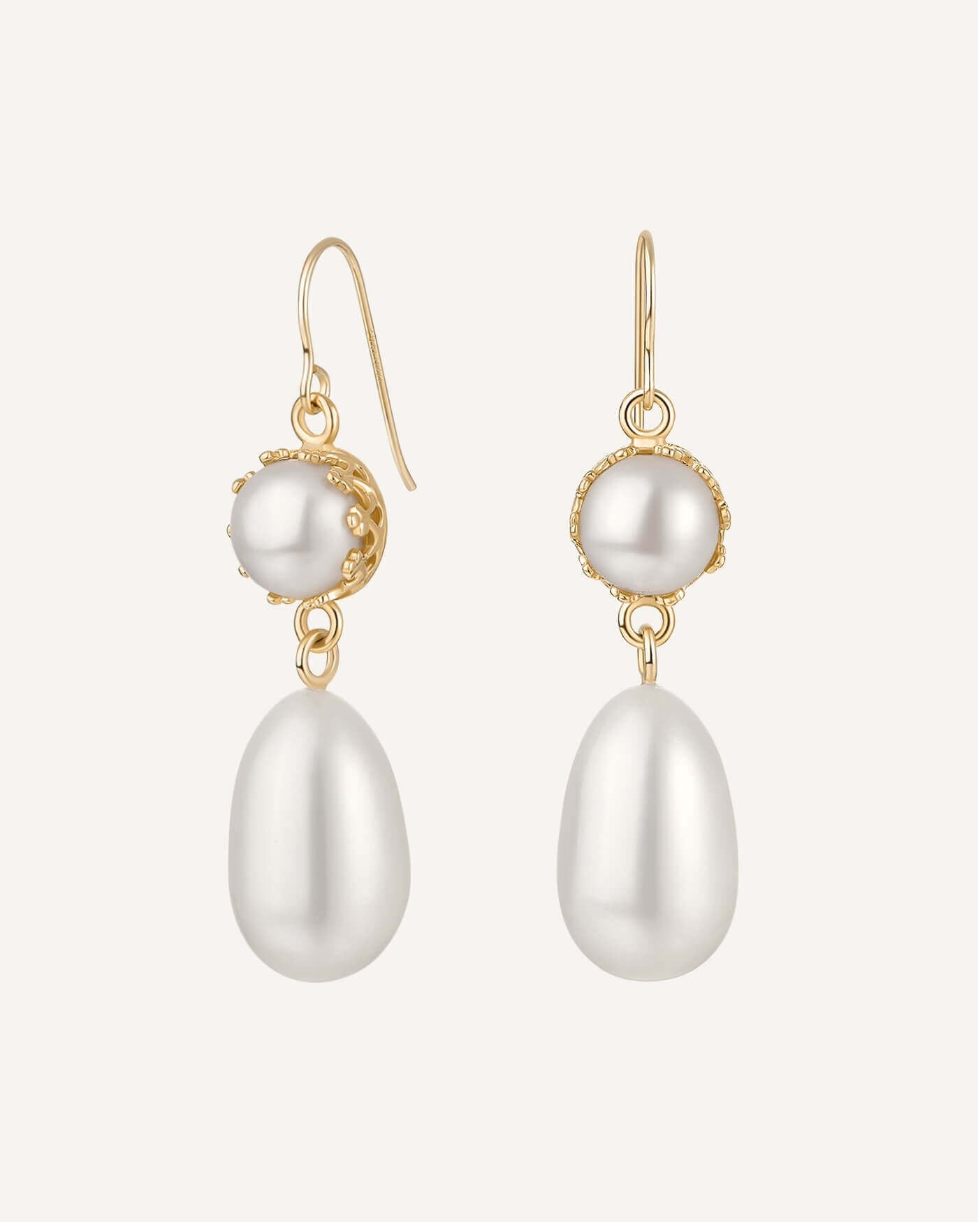 Pearl earrings with gold hooks on a white background