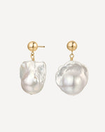 Pearl earrings with gold posts on a white background